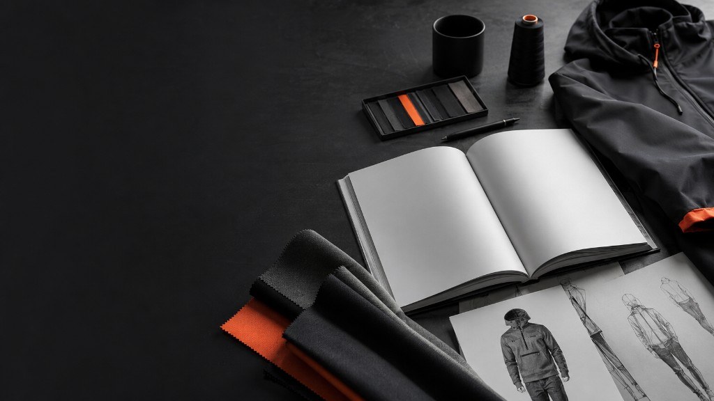 Open notebook, garment sketches and fabric swatches beside a technical jacket