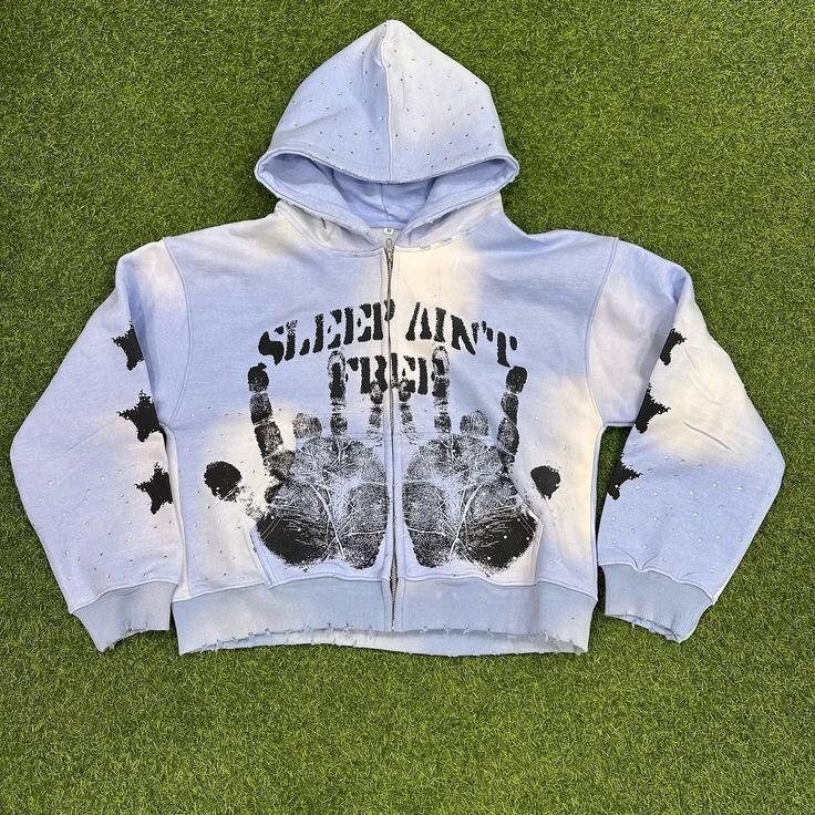 Light blue acid-wash zip hoodie with handprint graphics and rhinestones