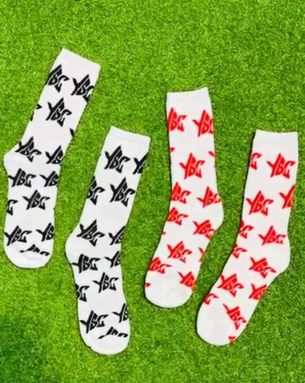 Custom white athletic crew socks with black and red logo patterns detail 1