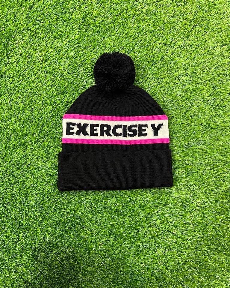 Black pom-pom knit beanie with pink and white striped lettered band